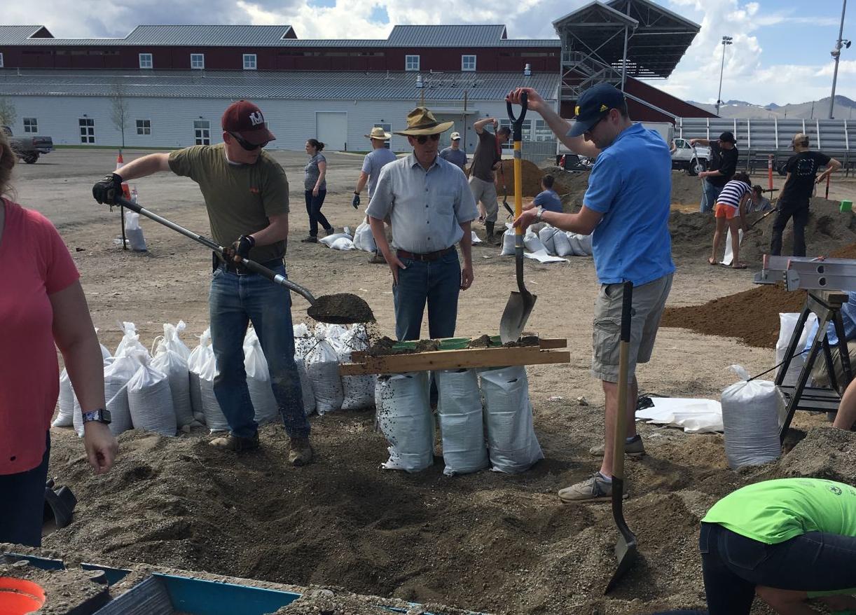 Volunteers help bag sand